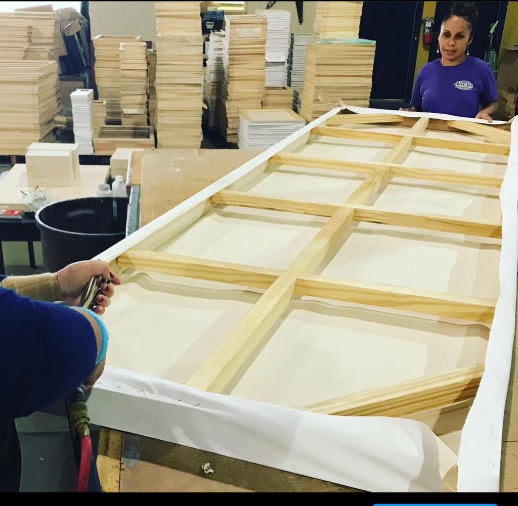 Sunbelt Manufacturing | Employees Hand Stretching Canvas on Wood Frame